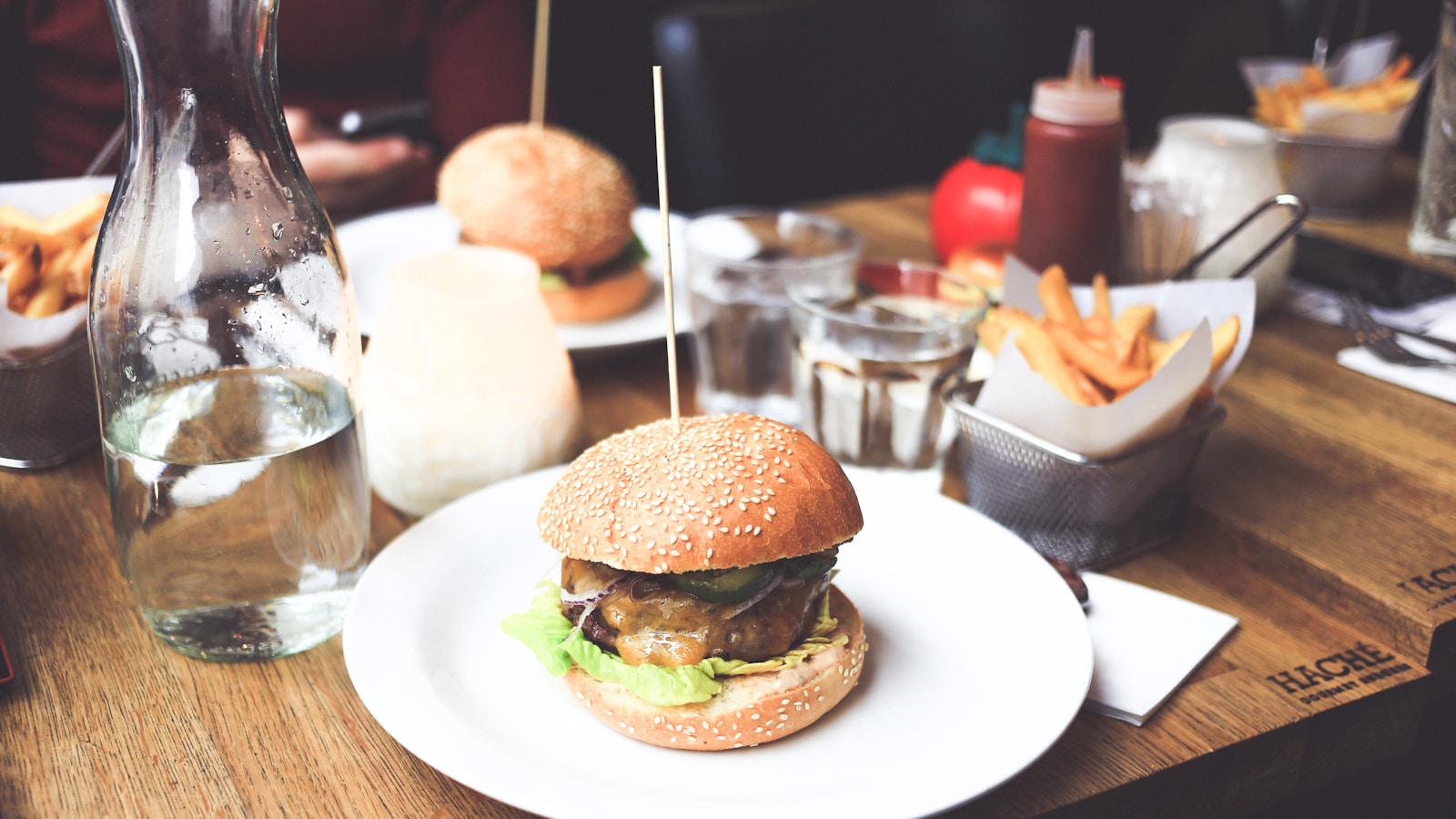 A gourmet burger served with a side of fries